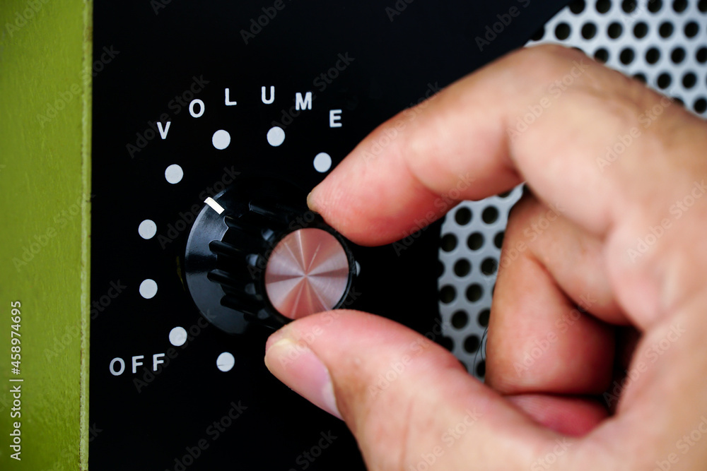 Hand Adjusting Volume Control.use Hand To Adjust The Volume At The 