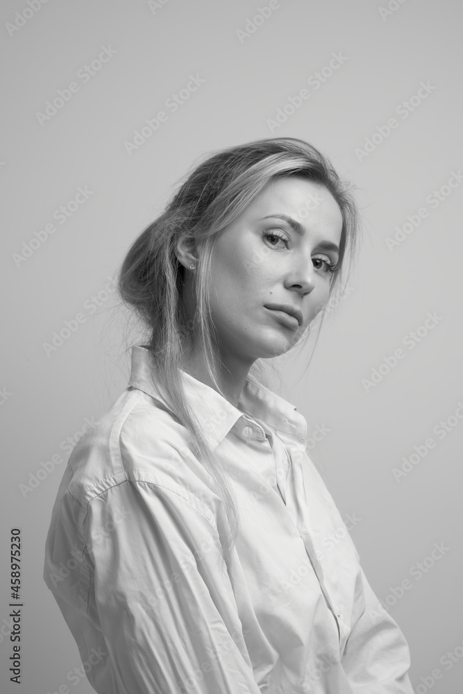Close up black white portrait of sexy blond young woman in white mens shirt posing at home, beautiful girl with tousled hair studio shot Close up black white portrait of sexy blond young woman in white mens shirt posing at home, beautiful girl with tousled hair studio shot