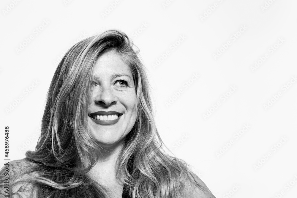 Black and white portrait of smiling middle-aged woman on white background Black and white portrait of smiling middle-aged woman on white background
