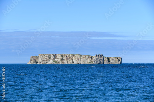 Flat island at sea. Arctic landscape in summer time. Franz Jozef Land archipelago.