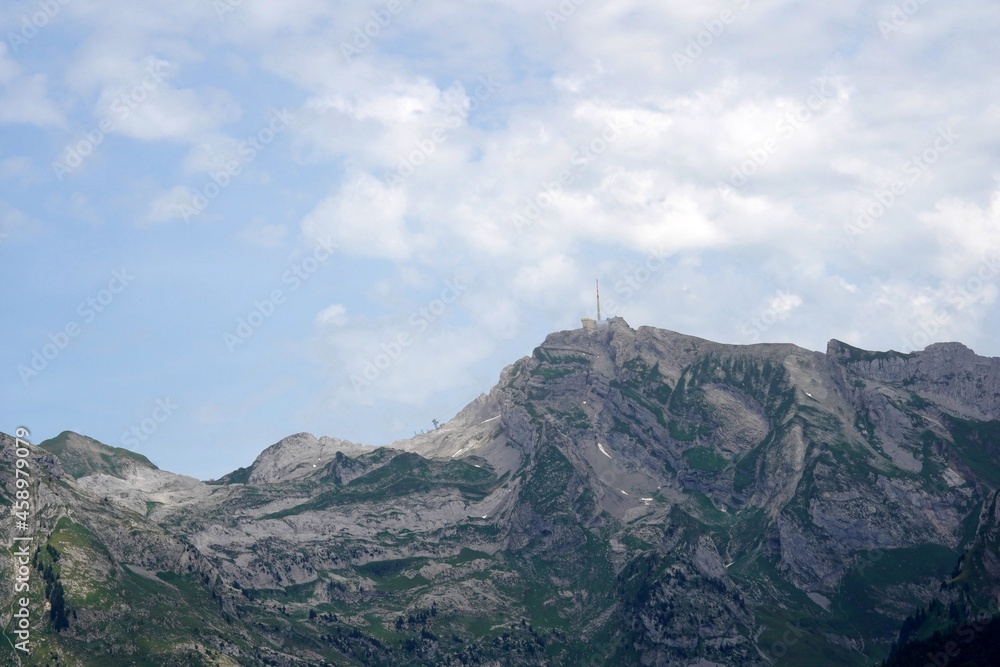 Panoramic view of Saentis mountain in Switzerland in summer time. It is an important landmark of the region and one of the highest mountains in Alps in general. Copy space available. Panoramic view of Saentis mountain in Switzerland in summer time. It is an important landmark of the region and one of the highest mountains in Alps in general. Copy space available.