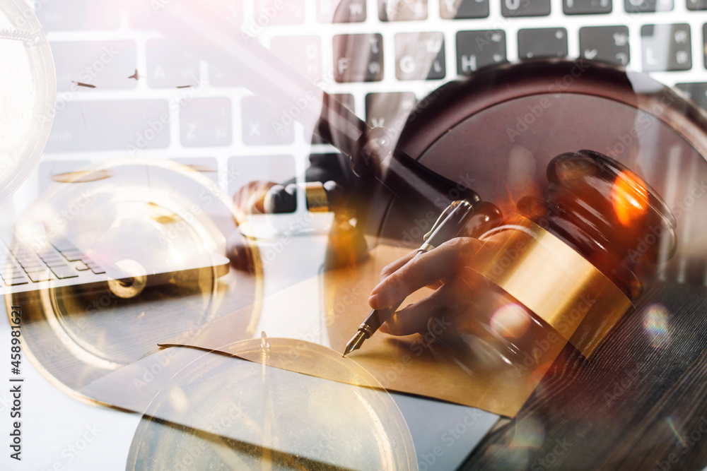 Business and lawyers discussing contract papers with brass scale on desk in office. Law, legal services, advice, justice and law concept picture with film grain effect Business and lawyers discussing contract papers with brass scale on desk in office. Law, legal services, advice, justice and law concept picture with film grain effect