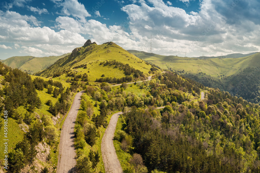 Aerial drone point of view over the serpentine mountain road near the Pushkin Pass in Armenia. Concept of transportation and tourist attractions of Transcaucasia