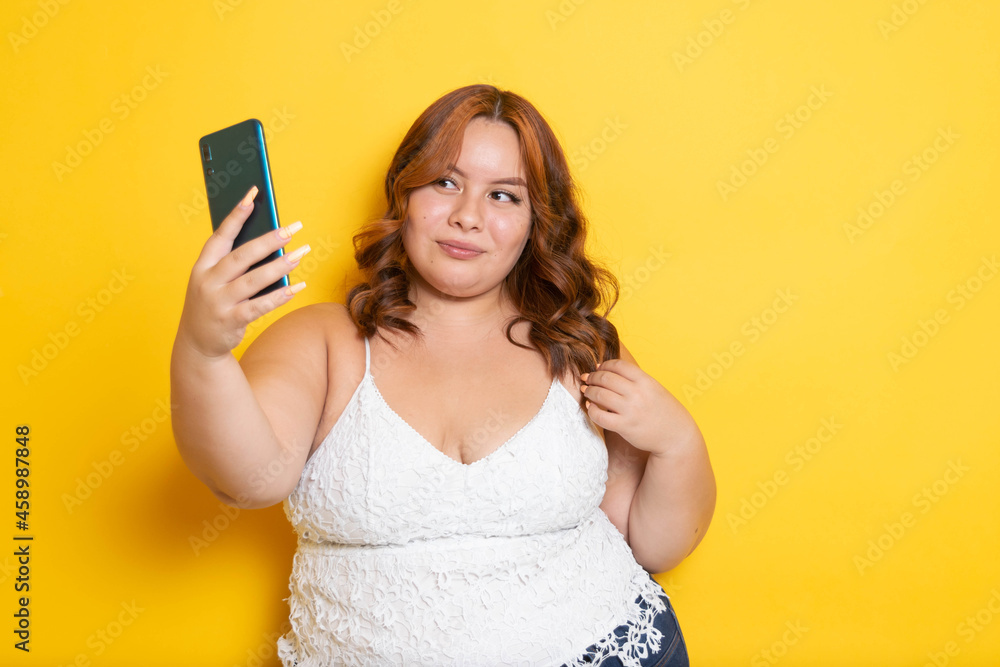 beautiful plus size young women using phone to make video call and take selfies beautiful plus size young women using phone to make video call and take selfies