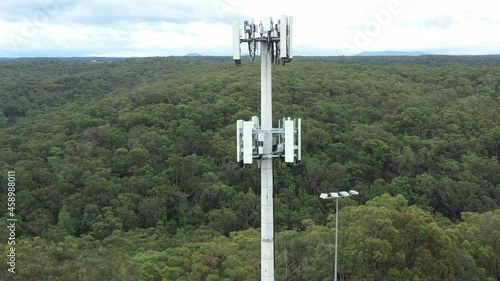 Drone aerial footage flying up and down a monopole telecommunications tower bundle at various heights and speed photo