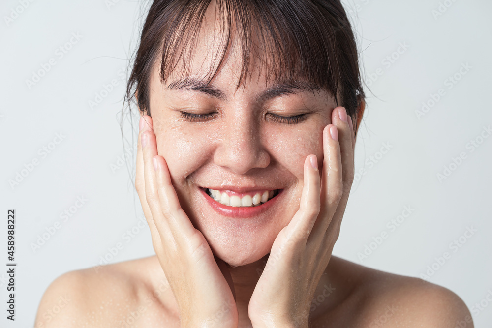 Freshness smiling of young Asian female with water drop on her face. Freshness smiling of young Asian female with water drop on her face.
