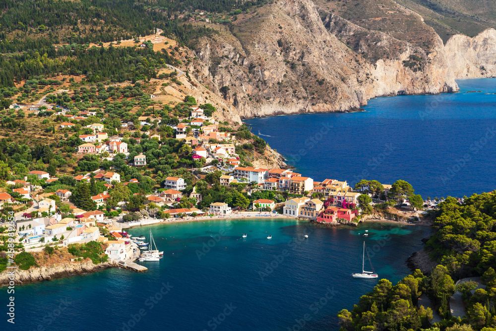 Top view at Asos village, Assos peninsula and fantastic blue Ionian Sea water. Aerial view, summer scenery of famous and extremely popular travel destination in Cephalonia, Greece, Europe.