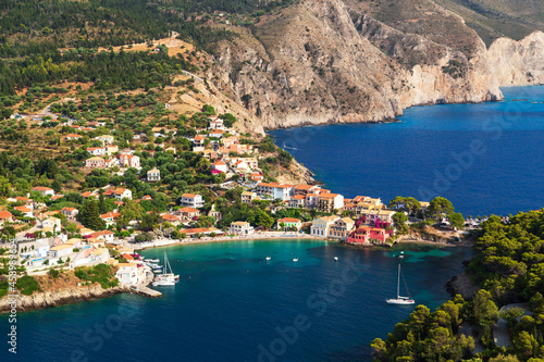 Fototapeta Naklejka Na Ścianę i Meble -  Top view at Asos village, Assos peninsula and fantastic blue Ionian Sea water. Aerial view, summer scenery of famous and extremely popular travel destination in Cephalonia, Greece, Europe.