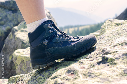 Tourist legs. The mountains. Trekking shoes. Sports sneakers