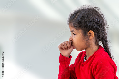 Little girl sucking her thumb. insecure, child. bad habit. photo