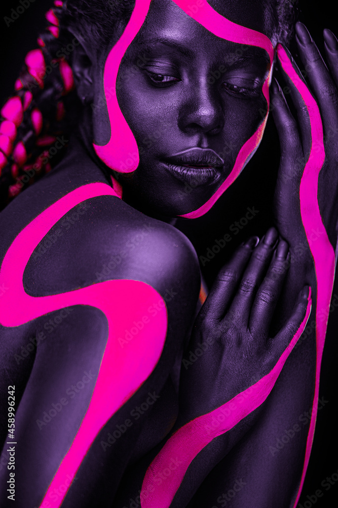 Neon colors. Pink and black body paint. Woman with face art. Young