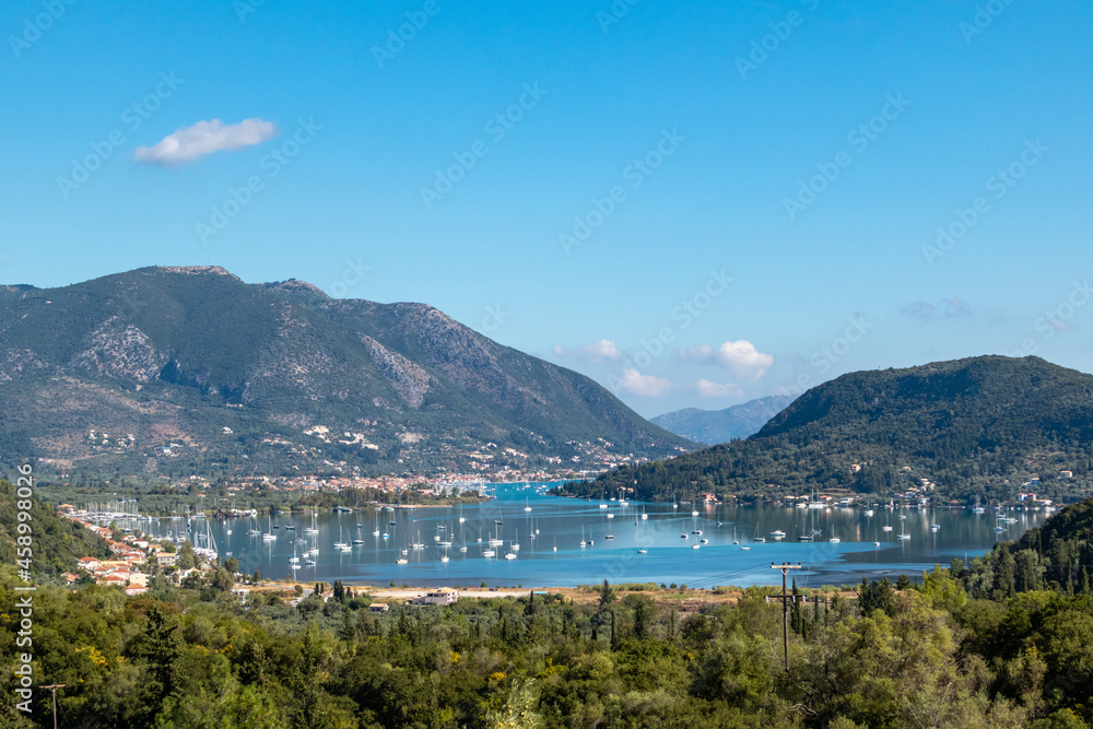 Vlicho bay view from hills of Lefkada island Katochori village, Ionian Islands, Greece. Boats, blue sea and sky surrounded by summer greenery