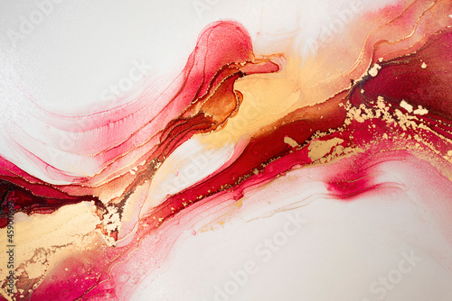 Luxury abstract fluid art painting in alcohol ink technique, mixture of red, yellow and gold paints. Imitation of marble stone cut, glowing golden circles. Tender and dreamy design. © Екатерина Птушко