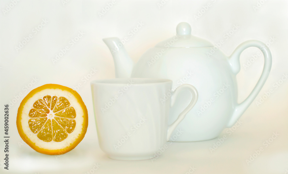 white teapot with a mug and lemon white teapot with a mug and lemon