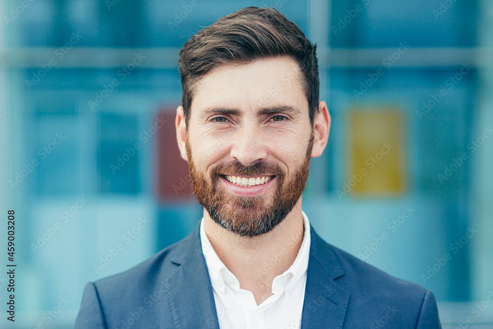Portrait of young handsome man with beard, businessman looking at camera and smiling close up photo Portrait of young handsome man with beard, businessman looking at camera and smiling close up photo