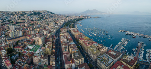 Panoramic aerial view of Naples downtown, view of the Vesuvius volcano over the city skyline facing the Mediterranean Sea, Campania, Italy. photo