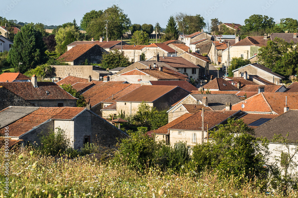 red roofs with red tiles of ols houses and farmhouses in the little French village Voisey in the Champagne Ardennes at sunset