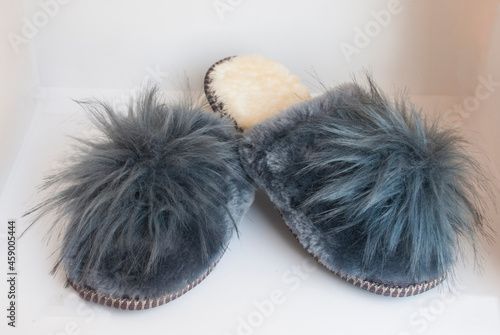 Grey home shoes with big pompon.