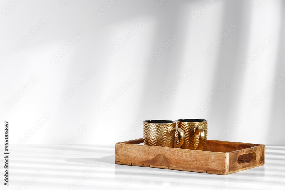 Golden mugs on white background and free space for your decoration. Golden mugs on white background and free space for your decoration.
