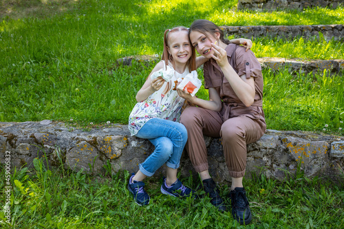 Happy sisters have picnic outdoor © Vadim