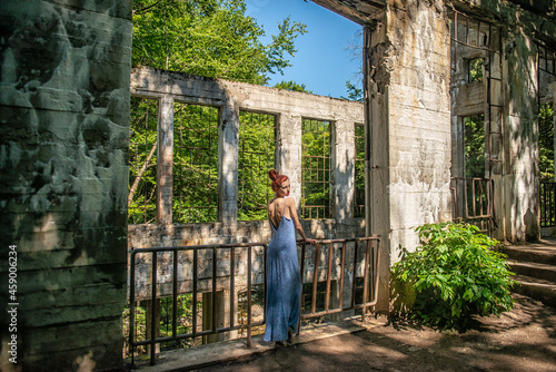 Beautiful redheaded woman in front of the stone ruins of the Willson Carbide Mill in Gatineau Park near Ottawa, Canada. © Robert McAlpine