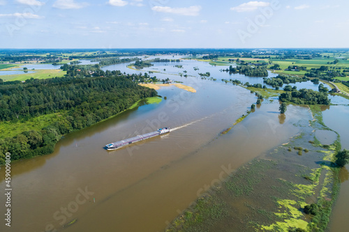 Wallpaper Mural Aerial view of an industrial ship sailing up the river IJssel during high water season in Fortmond and Welsumer Waarden, Gelderland and Overijssel, The Netherlands. Torontodigital.ca