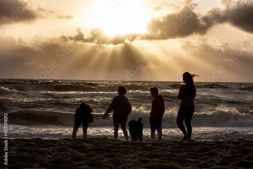 Fotografija silhouettes of four teenagers and a dog on the beach of Jutland, Denmark