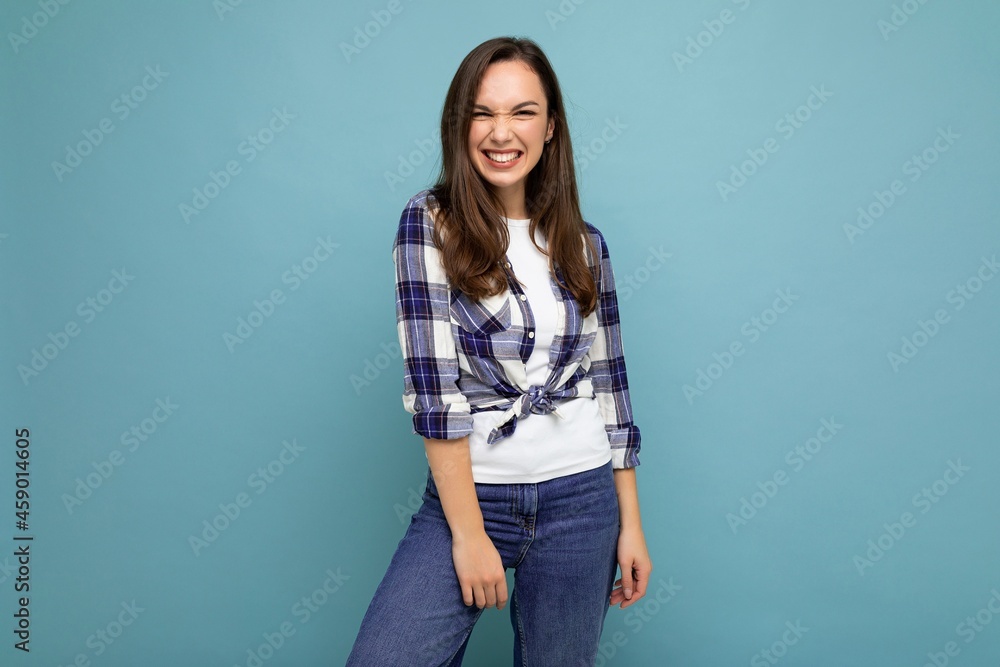 Portrait of positive cheerful fashionable woman in hipster outfit isolated on blue background with copy space Portrait of positive cheerful fashionable woman in hipster outfit isolated on blue background with copy space