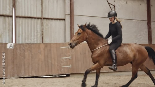 Woman Riding Bareback On Horse Around Paddock photo