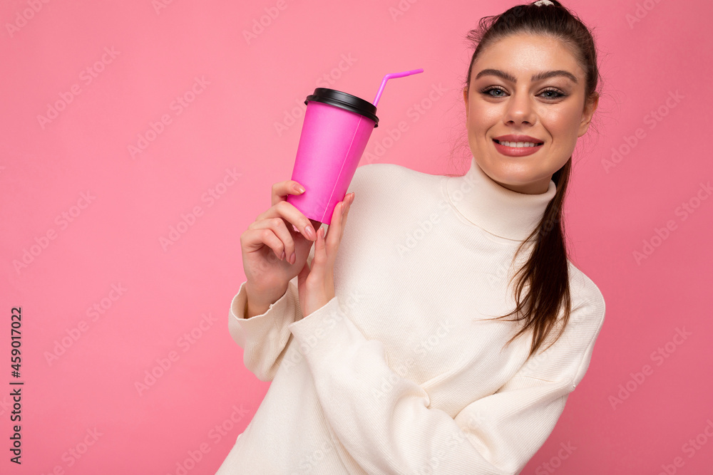 Closeup photo of attractive young happy smiling brunette woman wearing everyday stylish clothes isolated over colourful background wall holding paper cup for cutout drinking tea looking at camera Closeup photo of attractive young happy smiling brunette woman wearing everyday stylish clothes isolated over colourful background wall holding paper cup for cutout drinking tea looking at camera