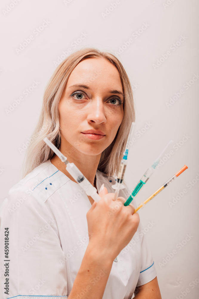 Young nurse holding many syringes with covid vaccine in her hands
Young nurse holding many syringes with covid vaccine in her hands