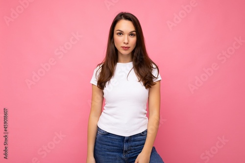 Photo shot of cute nice charming gorgeous attractive pretty youngster happy woman wearing white t-shirt for mockup isolated over colorful background with copy space