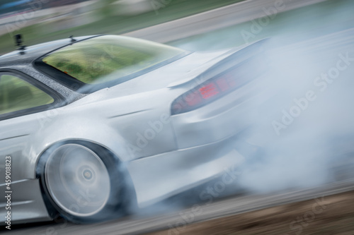 Highspeed drifting done by a professional at a race track 