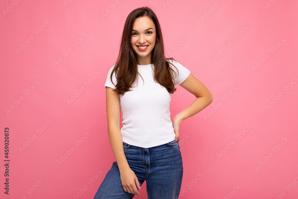 Portrait of positive cheerful fashionable woman in casual t-shirt for mock up isolated on pink background with copy space Portrait of positive cheerful fashionable woman in casual t-shirt for mock up isolated on pink background with copy space