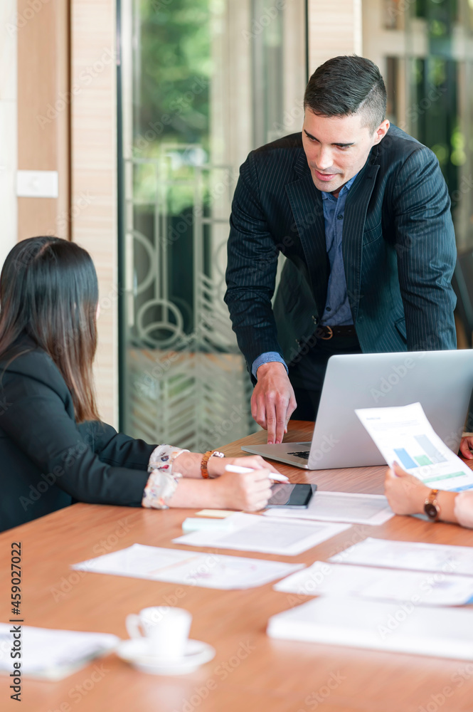 Young executive businessman giving new idea about business plan to his partnership at office. Young executive businessman giving new idea about business plan to his partnership at office.