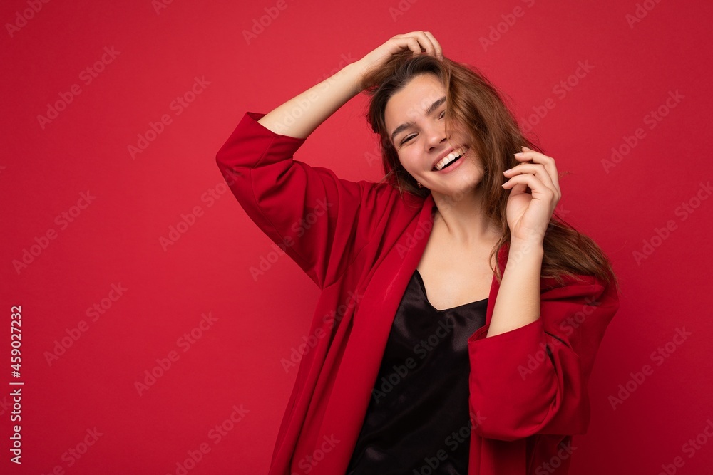 Portrait of young attractive caucasian hipster woman in trendy casual clothes. Sexy carefree female person posing isolated near red wall in studio. Empty space Portrait of young attractive caucasian hipster woman in trendy casual clothes. Sexy carefree female person posing isolated near red wall in studio. Empty space
