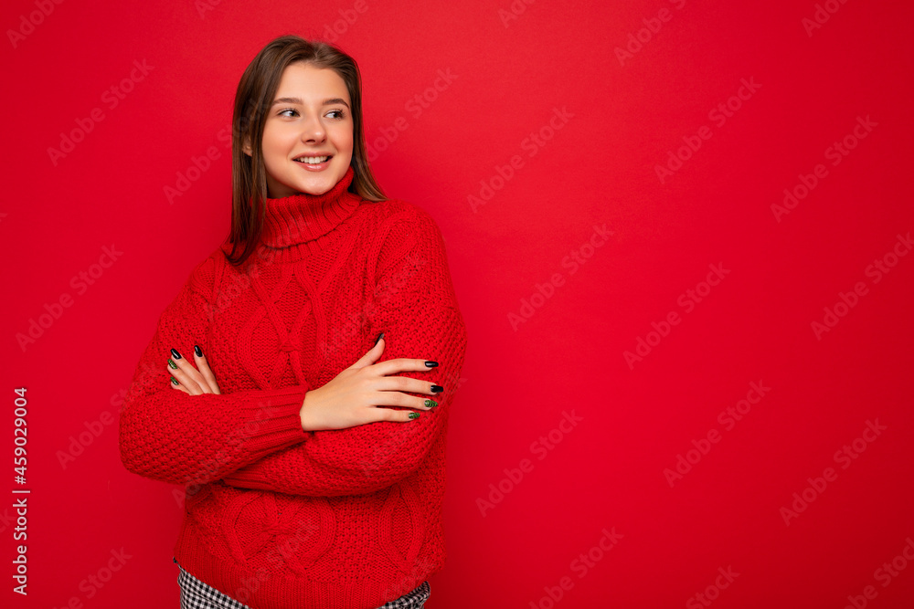Obraz premium Shot of attractive happy smiling young woman wearing casual outfit standing isolated over colourful background with empty space looking to the side