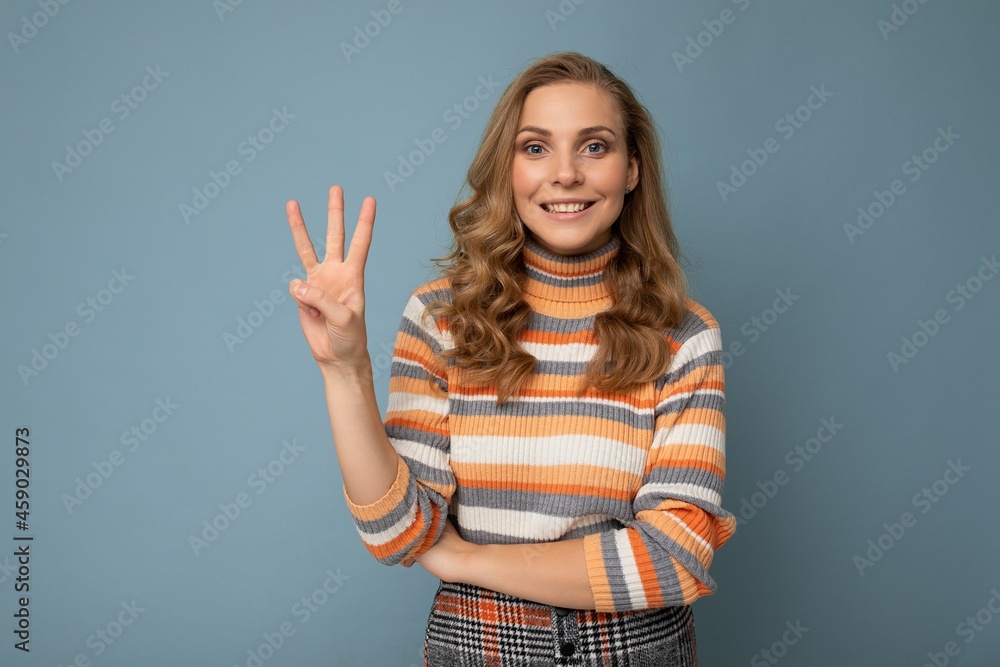 Photo of young positive happy smiling beautiful woman with sincere emotions wearing stylish clothes isolated over background with copy space and showing three fingers Photo of young positive happy smiling beautiful woman with sincere emotions wearing stylish clothes isolated over background with copy space and showing three fingers