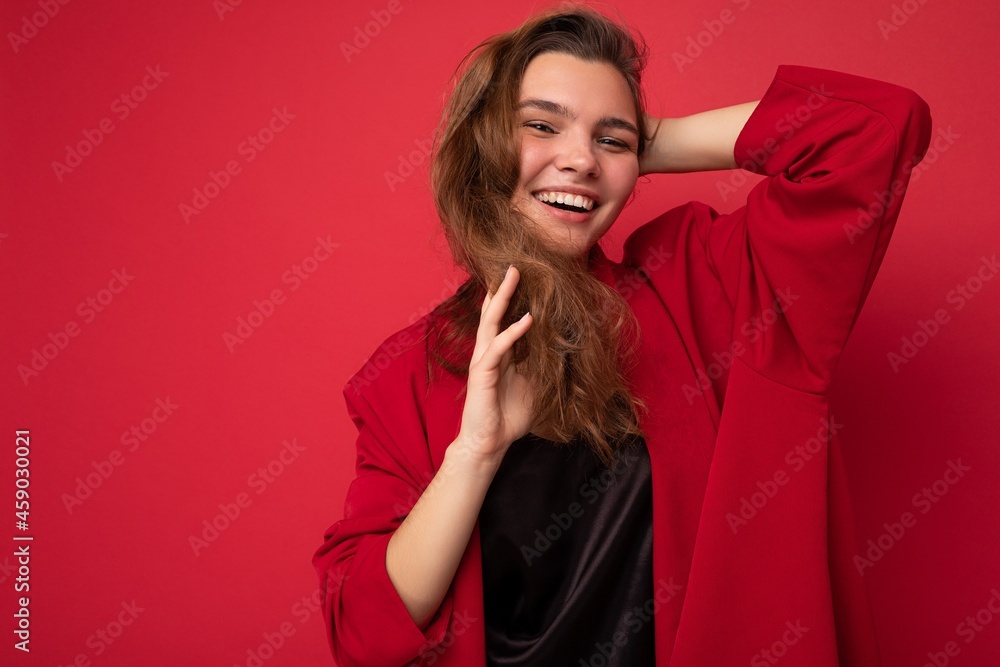 Young beautiful european stylish brunette woman wearing black blouse top and red cardigan isolated over red background with positive sincere emotions. Simple and natural looking at the camera. Free Young beautiful european stylish brunette woman wearing black blouse top and red cardigan isolated over red background with positive sincere emotions. Simple and natural looking at the camera. Free