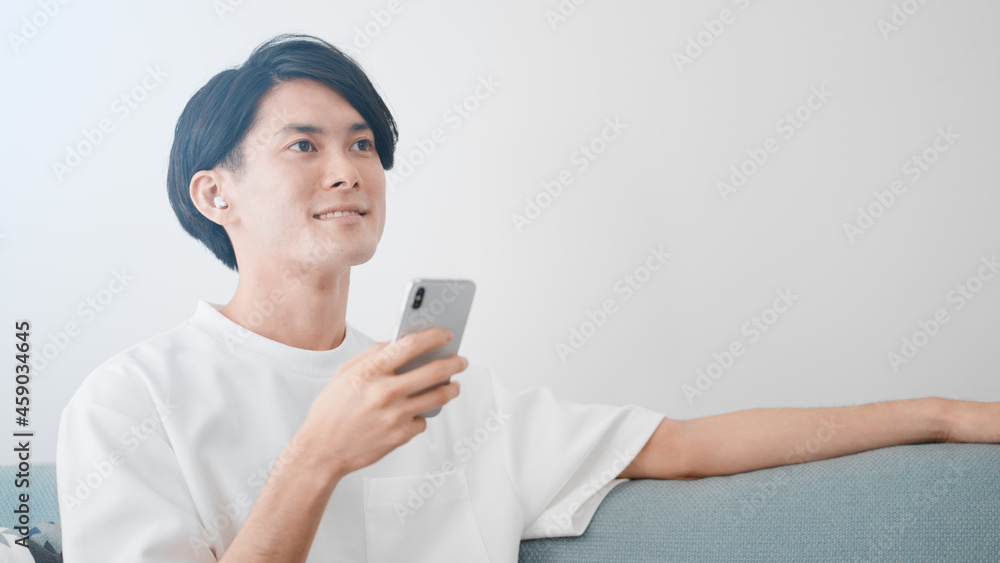 スマートフォンで音楽を聴く男性 スマートフォンで音楽を聴く男性