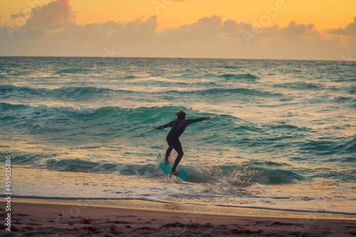 man surfing beach waves horizon sunrise sky clouds surf people travel vacation sport ocean Miami Florida 