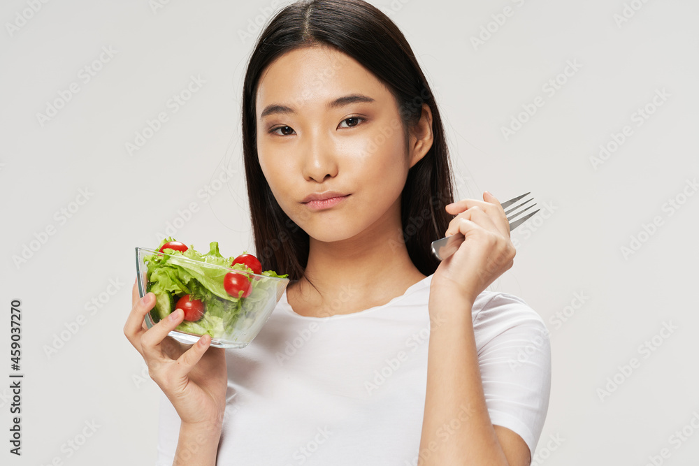woman salads plates asian looks t-shirt light background woman salads plates asian looks t-shirt light background