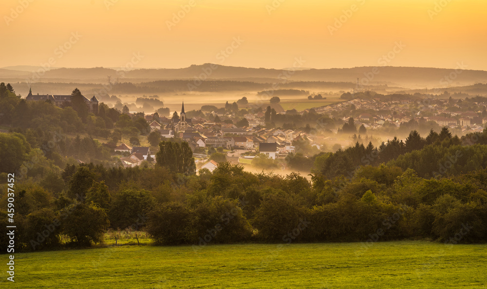 Landscape with the village of Longeville les Saint Avold at sunrise in Lorraine France