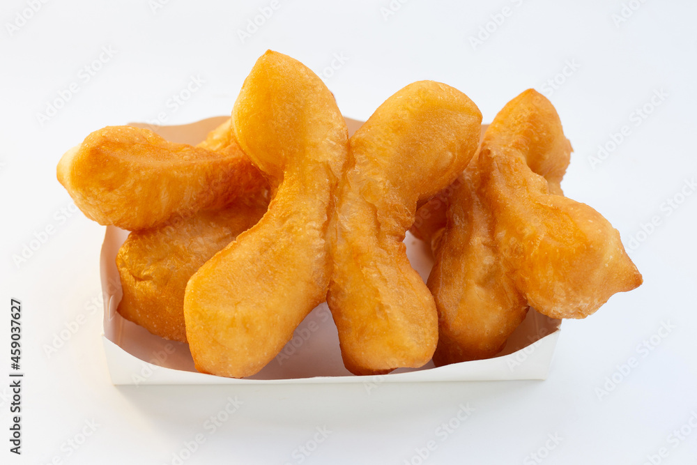 Deep-fried dough sticks or chinese bread sticks on white background. Deep-fried dough sticks or chinese bread sticks on white background.