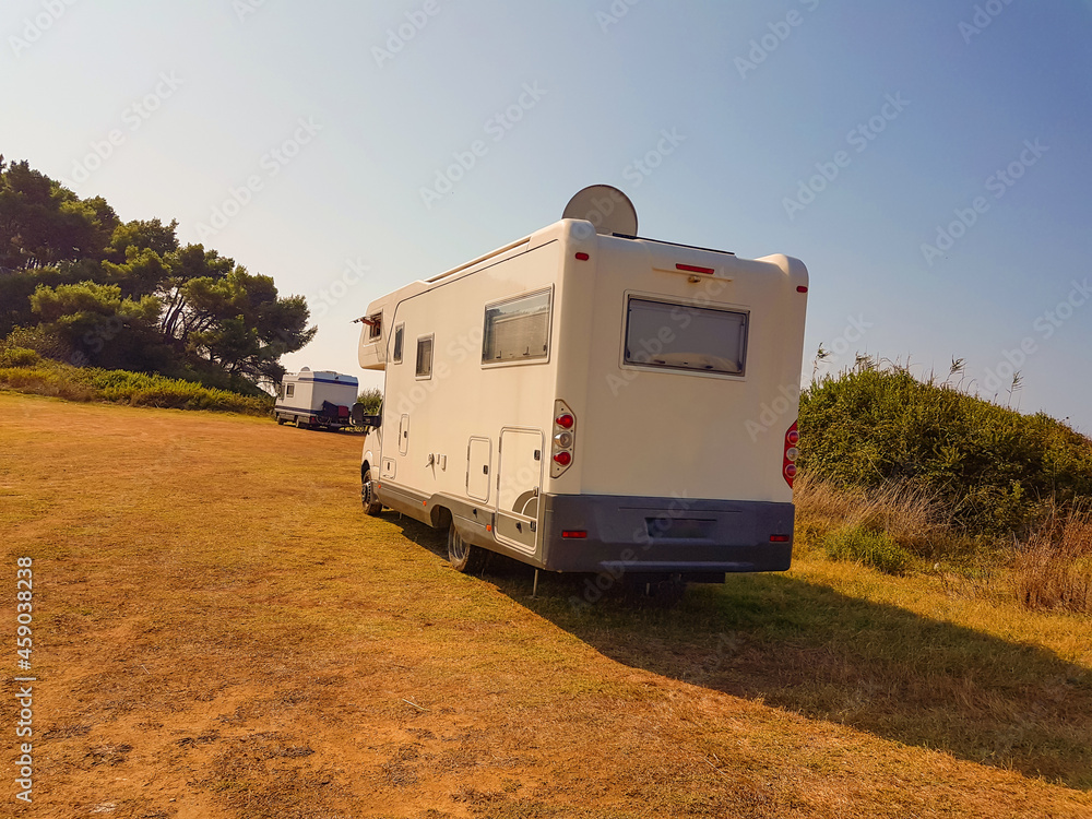 caravan car uphill in autumn colors by the pine trees