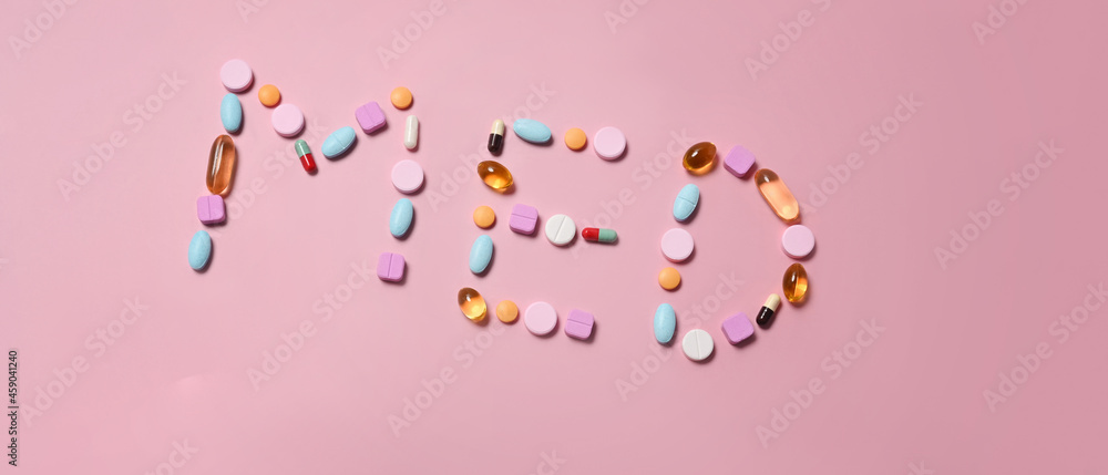 Medical pills on pink background. Medical health care concept.