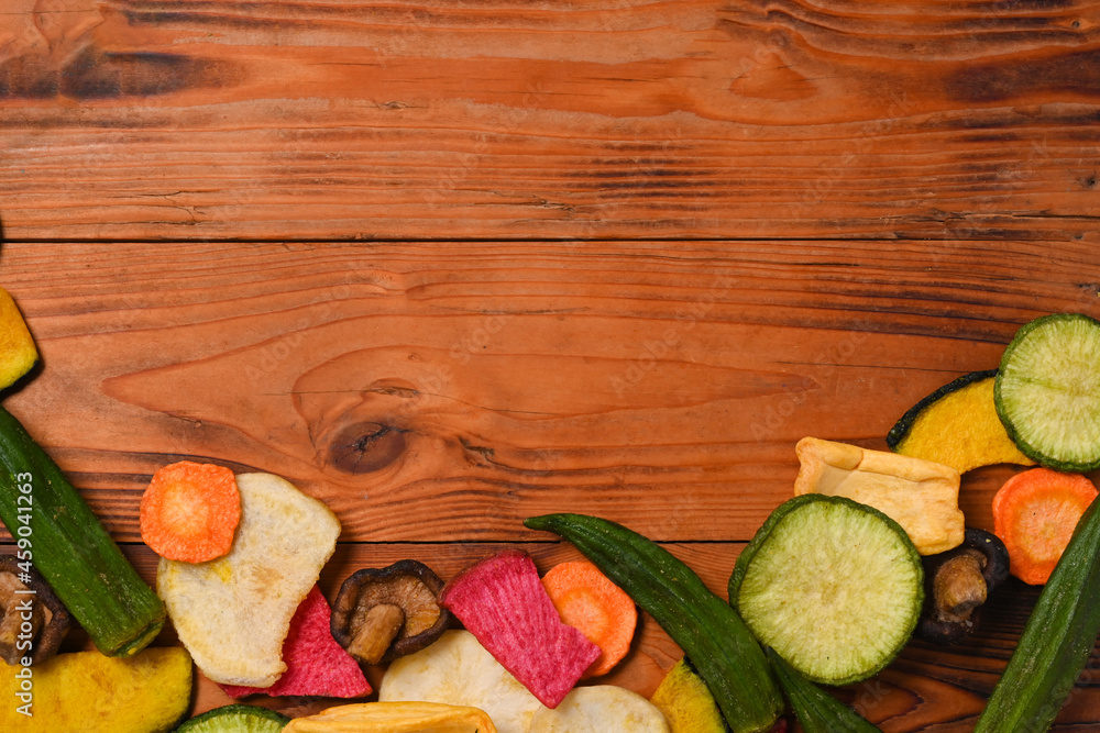 Dried vegetables with green radish, carrots, potato, beetroot and shiitake mushrooms on wooden background.
