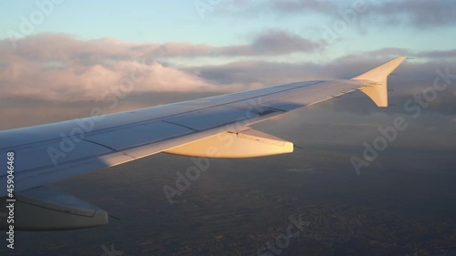 Aerial view of sunrise through airliner window.