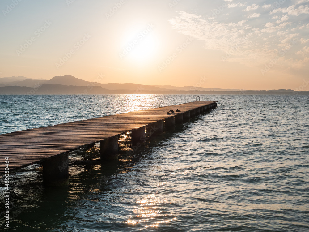 Lake Garda Jetty at Sunrise called Il Pontile di Sirmione in Summer Lake Garda Jetty at Sunrise called Il Pontile di Sirmione in Summer