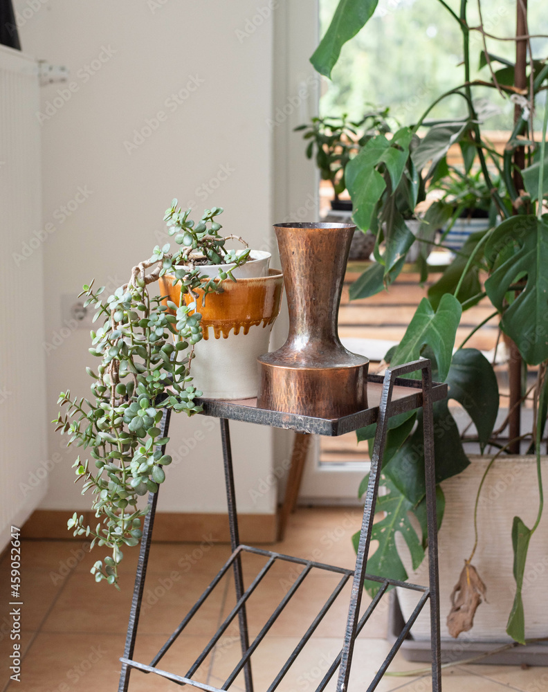 Mid-century modern copper vase and a ceramic pot on a metal table
